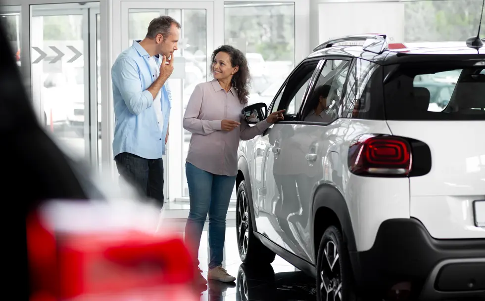happy couple looking for new lease car